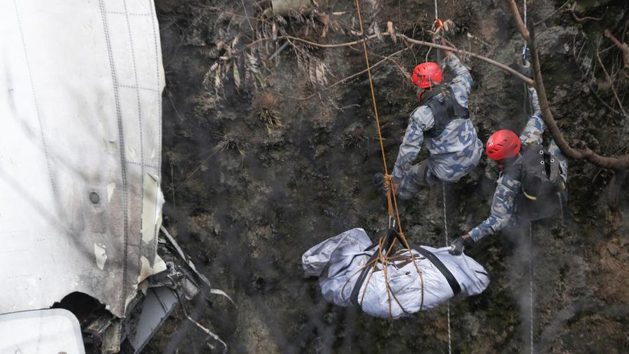A rescue team recovers the body of a victim from the site of the plane crash of a Yeti Airlines operated aircraft, in Pokhara, Nepal January 16, 2023. REUTERS/Rohit Giri NO RESALES. NO ARCHIVES