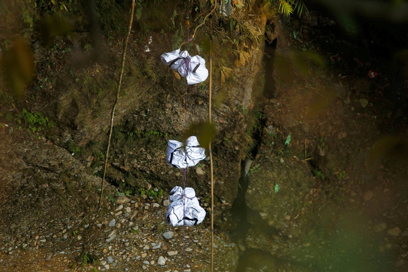 A rescue team recovers the bodies of victims from the site of the plane crash of a Yeti Airlines-operated aircraft, in Pokhara, Nepal January 16, 2023. REUTERS/Sulav Shrestha NO RESALES. NO ARCHIVES  REFILE - CORRECTING THE NUMBER OF BODIES    TPX IMAGES OF THE DAY