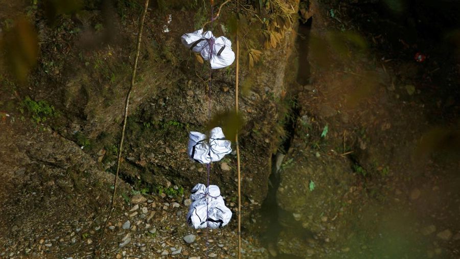 A rescue team recovers the bodies of victims from the site of the plane crash of a Yeti Airlines-operated aircraft, in Pokhara, Nepal January 16, 2023. REUTERS/Sulav Shrestha NO RESALES. NO ARCHIVES  REFILE - CORRECTING THE NUMBER OF BODIES    TPX IMAGES OF THE DAY