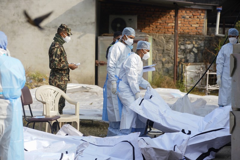A rescue team recovers the bodies of victims from the site of the plane crash of a Yeti Airlines-operated aircraft, in Pokhara, Nepal January 16, 2023. REUTERS/Sulav Shrestha NO RESALES. NO ARCHIVES  REFILE - CORRECTING THE NUMBER OF BODIES    TPX IMAGES OF THE DAY