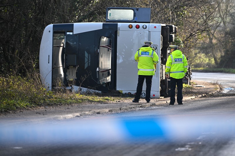 1457084233 CANNINGTON, SOMERSET - JANUARY 17: An aerial view of police at the scene after the early-morning crash on January 17, 2023 near Cannington, Somerset, England. The bus was carrying workers at Hinkley Point C, the nuclear power station about 8 miles from the scene of the crash. (Photo by Finnbarr Webster/Getty Images)