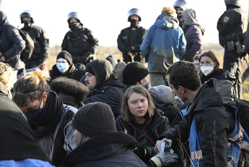 APTOPIX Germany Coal Protest Police officers carry Swedish climate activist Greta Thunberg away from the edge of the Garzweiler II opencast lignite mine during a protest action by climate activists after the clearance of Luetzerath, Germany, Tuesday, Jan. 17, 2023. After the eviction of Luetzerath ended on Sunday, coal opponents continued their protests on Tuesday at several locations in North Rhine-Westphalia. (Federico Gambarini/dpa via AP)