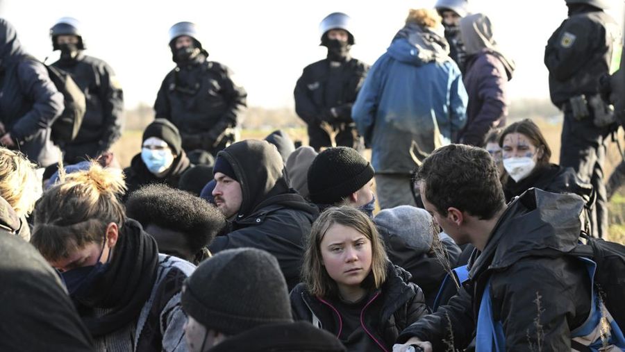 Police officers carry Swedish climate activist Greta Thunberg away from the edge of the Garzweiler II opencast lignite mine during a protest action by climate activists after the clearance of Luetzerath, Germany, Tuesday, Jan. 17, 2023. After the eviction of Luetzerath ended on Sunday, coal opponents continued their protests on Tuesday at several locations in North Rhine-Westphalia. (Federico Gambarini/dpa via AP)