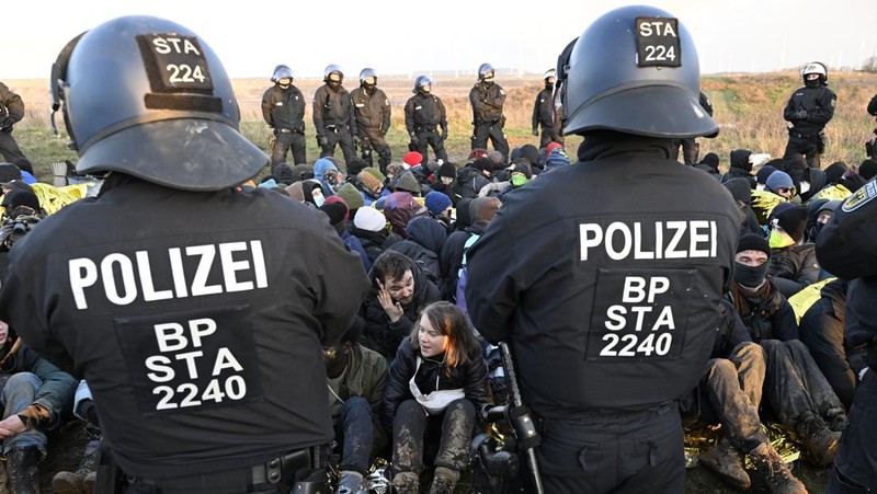 Police officers carry Swedish climate activist Greta Thunberg away from the edge of the Garzweiler II opencast lignite mine during a protest action by climate activists after the clearance of Luetzerath, Germany, Tuesday, Jan. 17, 2023. After the eviction of Luetzerath ended on Sunday, coal opponents continued their protests on Tuesday at several locations in North Rhine-Westphalia. (Federico Gambarini/dpa via AP)