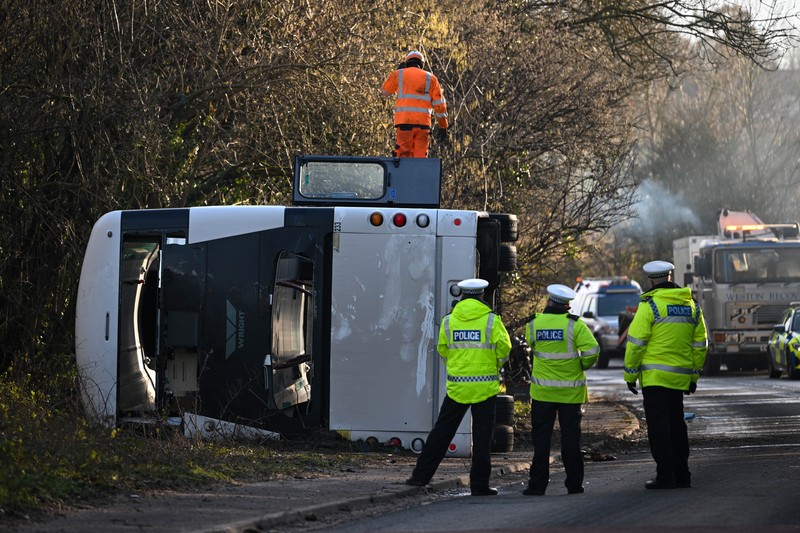 1457084233 CANNINGTON, SOMERSET - JANUARY 17: An aerial view of police at the scene after the early-morning crash on January 17, 2023 near Cannington, Somerset, England. The bus was carrying workers at Hinkley Point C, the nuclear power station about 8 miles from the scene of the crash. (Photo by Finnbarr Webster/Getty Images)