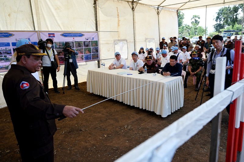 Para penjinak ranjau Ukraina menyaksikan ledakan bom yang terkendali di sebuah ladang ranjau di desa Preytotoeung, provinsi Battambang, Kamboja, Kamis, 19 Januari 2023. Lima belas penjinak ranjau Ukraina dilatih oleh para ahli di Kamboja yang merupakan salah satu yang terbaik di dunia karena berpengalaman membersihkan sisa-sisa makanan perang selama hampir tiga dekade. (AP Photo/Heng Sinith)