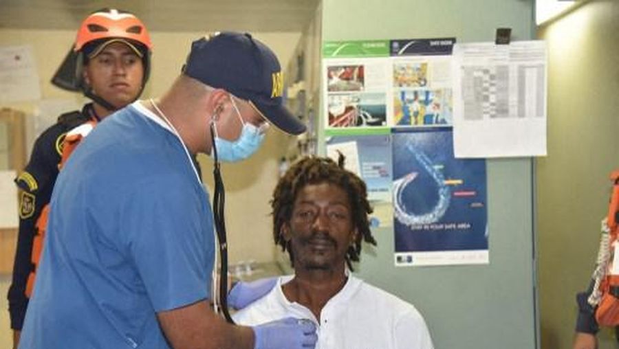 This undated handout picture released on January 18, 2023 by the Colombian National Navy shows Dominican Elvis Fracois being checked after his rescue on the caribbean sea in Colombia. - A Dominican man was lost for almost a month aboard a sailboat in the Caribbean Sea and survived eating ketchup before being rescued in Colombian waters, the country's naval authority reported Wednesday. (Photo by Colombian National Navy / AFP) / RESTRICTED TO EDITORIAL USE - MANDATORY CREDIT 