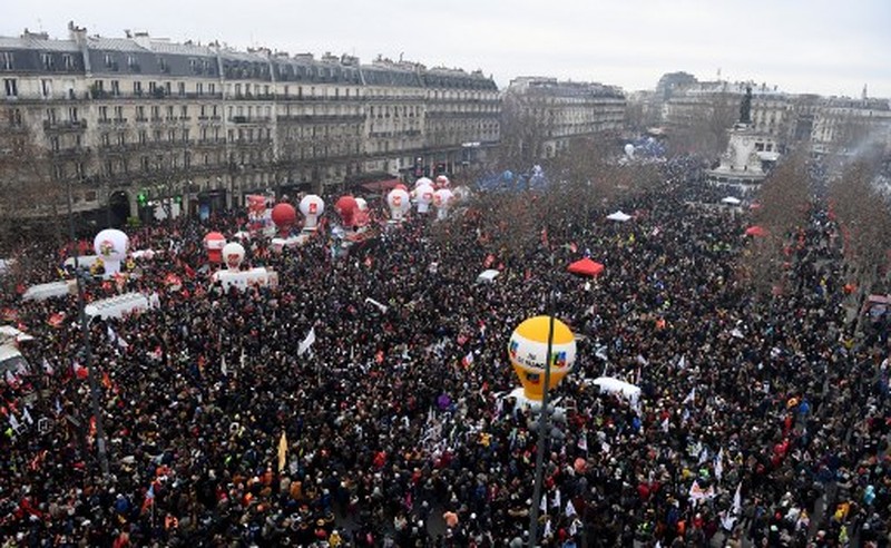Para pengunjuk rasa berbaris melalui jalan-jalan Paris sebagai bagian dari protes dan pemogokan nasional terhadap rencana reformasi Pensiun Presiden Macron dan kenaikan biaya hidup pada 19 Januari 2023 di Paris, Prancis. Menyusul pengumuman pemerintah Prancis untuk mendorong usia pensiun dari 62 menjadi 64, serikat pekerja menyerukan aksi sosial massal dengan karyawan di bidang transportasi, pendidikan, energi, dan layanan kesehatan bergabung dengan pemogokan nasional, dengan protes besar di seluruh Prancis. Serikat CGT Prancis juga mengancam akan memutus pasokan listrik untuk anggota parlemen dan pengusaha di tengah pemogokan nasional. (Kiran Ridley/Getty Images)