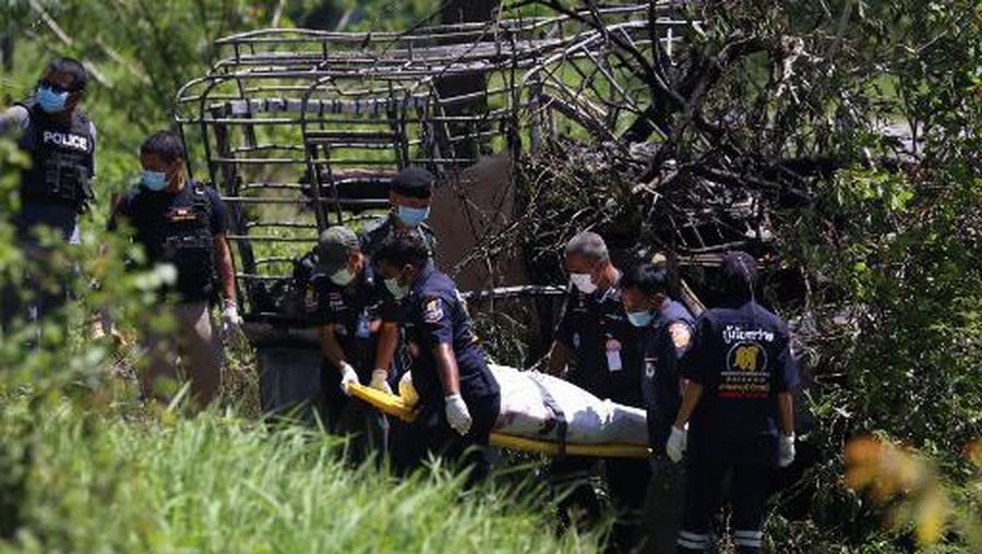Police investigators recover a body at the site of an ambush on a car by suspected militants that authorities said killed three people in Sai Buri district in southern Thailand's Pattani province on April 24, 2021. (Photo by Tuwaedaniya MERINGING / AFP)