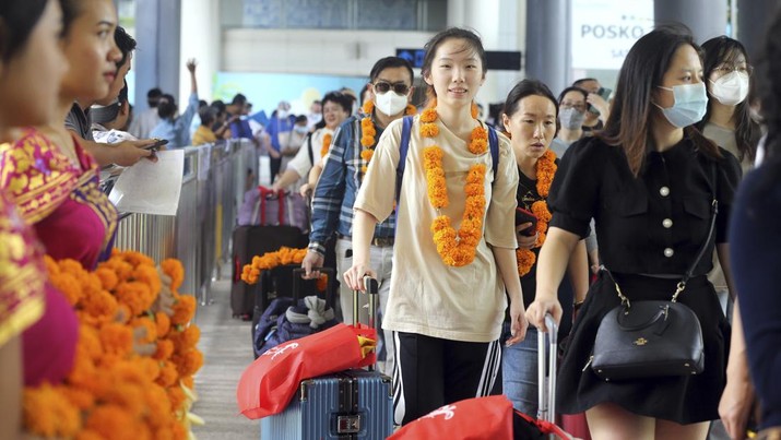 Virus Outbreak Indonesia Lunar New Year Chinese tourists arrive at Ngurah Rai international airport in Bali, Indonesia on Sunday, Jan. 22, 2023. A direct flight from China landed in Indonesia's resort island of Bali for the first time on Sunday in nearly three years after the route was cancelled due to the pandemic. (AP Photo/Firdia Lisnawati)