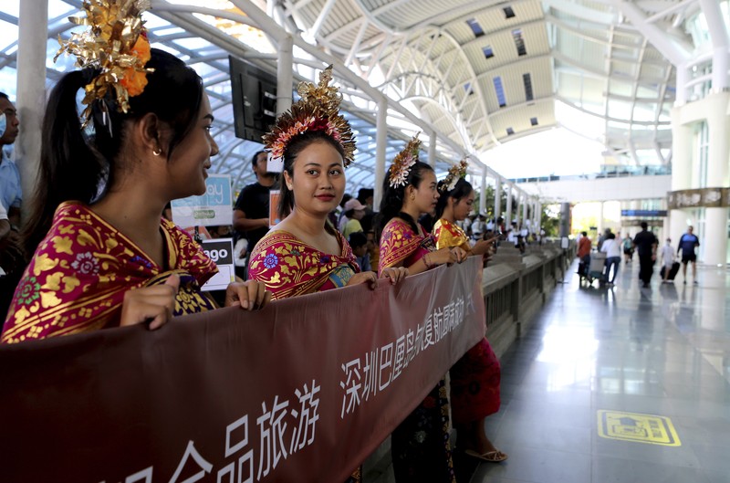 Virus Outbreak Indonesia Lunar New Year Chinese tourists arrive at Ngurah Rai international airport in Bali, Indonesia on Sunday, Jan. 22, 2023. A direct flight from China landed in Indonesia's resort island of Bali for the first time on Sunday in nearly three years after the route was cancelled due to the pandemic. (AP Photo/Firdia Lisnawati)
