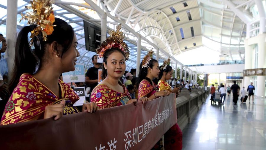 Chinese tourists arrive at Ngurah Rai international airport in Bali, Indonesia on Sunday, Jan. 22, 2023. A direct flight from China landed in Indonesia's resort island of Bali for the first time on Sunday in nearly three years after the route was cancelled due to the pandemic.  (AP Photo/Firdia Lisnawati)