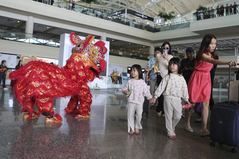 Virus Outbreak Indonesia Lunar New Year Chinese tourists arrive at Ngurah Rai international airport in Bali, Indonesia on Sunday, Jan. 22, 2023. A direct flight from China landed in Indonesia's resort island of Bali for the first time on Sunday in nearly three years after the route was cancelled due to the pandemic. (AP Photo/Firdia Lisnawati)
