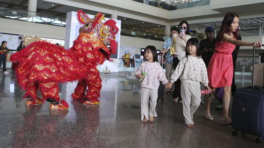 Chinese tourists arrive at Ngurah Rai international airport in Bali, Indonesia on Sunday, Jan. 22, 2023. A direct flight from China landed in Indonesia's resort island of Bali for the first time on Sunday in nearly three years after the route was cancelled due to the pandemic.  (AP Photo/Firdia Lisnawati)