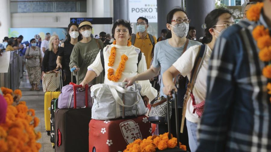 Chinese tourists arrive at Ngurah Rai international airport in Bali, Indonesia on Sunday, Jan. 22, 2023. A direct flight from China landed in Indonesia's resort island of Bali for the first time on Sunday in nearly three years after the route was cancelled due to the pandemic.  (AP Photo/Firdia Lisnawati)