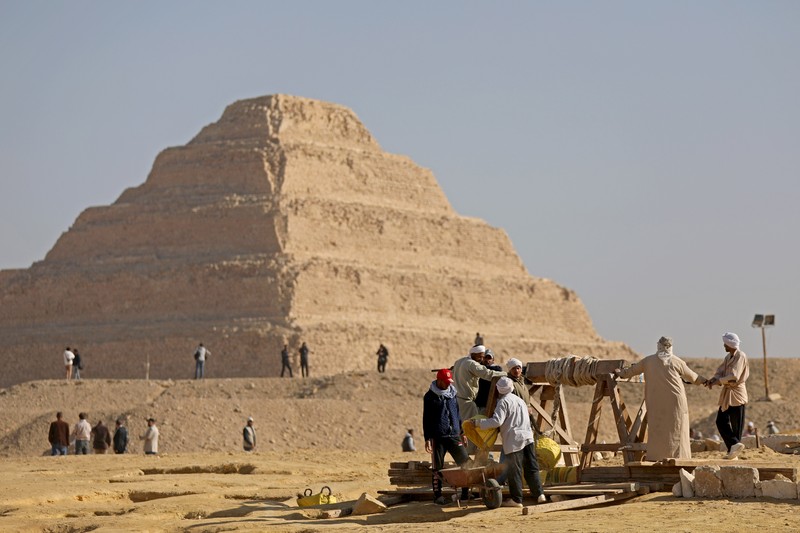 1459632878 CAIRO, EGYPT- JANUARY 26: Egyptian archaeological workers excavating the site of the Step Pyramid of Djoser in Saqqara during the announcement of new discoveries at the Director Bridge in Saqqara, on January 26, 2023 in Giza, Egypt. (Photo by Fadel Dawod/Getty Images)