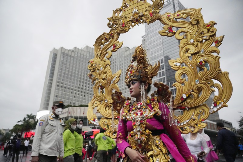 Indonesian President Joko Widodo, center, bangs a drum during the opening ceremony of the Kick Off 2023 ASEAN Indonesian Chairmanship in Jakarta, Indonesia, Sunday, Jan. 29, 2023. Indonesia will chair the Association of Southeast Asian Nations, ASEAN, for 2023. (AP Photo/Achmad Ibrahim)
