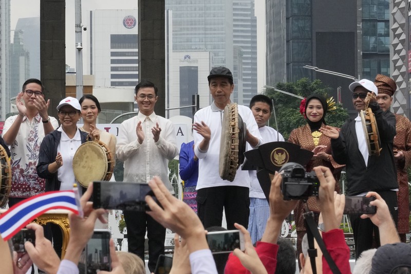 Indonesia Indonesian President Joko Widodo, center, bangs a drum during the opening ceremony of the Kick Off 2023 ASEAN Indonesian Chairmanship in Jakarta, Indonesia, Sunday, Jan. 29, 2023. Indonesia will chair the Association of Southeast Asian Nations, ASEAN, for 2023. (AP Photo/Achmad Ibrahim)