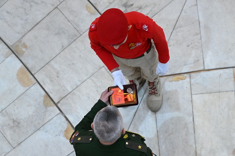 TOPSHOT - Para remaja Rusia menghadiri upacara untuk bergabung dengan gerakan kadet Tentara Pemuda patriotik di aula utama Museum Pertempuran Stalingrad di kota Volgograd, Rusia selatan, pada 25 Januari 2023. (KIRILL KUDRYAVTSEV/AFP via Getty Images)