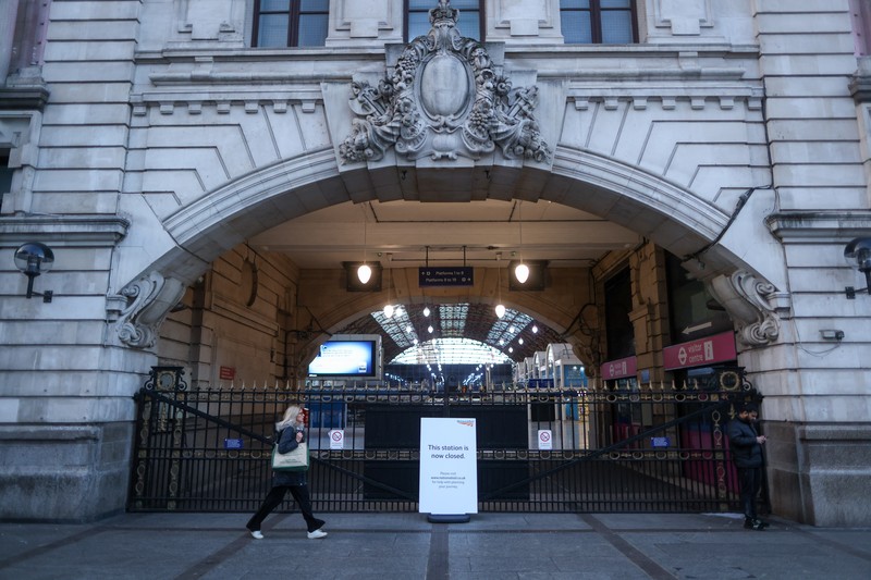 1246710070 A commuter passes a closed entrance to London Victoria railway station during joint strike action by train drivers, teachers, university staff and civil servants, in London, UK, on Wednesday, Feb. 1, 2023. The day of coordinated industrial action is expected to be Britains most severe day of strikes for over a decade, piling pressure on Prime Minister Rishi Sunaks Conservative administration to resolve disputes with public sector workers by making more generous offers on pay. Photographer: Chris Ratcliffe/Bloomberg via Getty Images