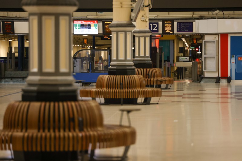 A commuter passes a closed entrance to London Victoria railway station during joint strike action by train drivers, teachers, university staff and civil servants, in London, UK, on Wednesday, Feb. 1, 2023. The day of coordinated industrial action is expected to be Britains most severe day of strikes for over a decade, piling pressure on Prime Minister Rishi Sunaks Conservative administration to resolve disputes with public sector workers by making more generous offers on pay. Photographer: Chris Ratcliffe/Bloomberg via Getty Images