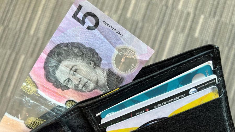 This photo illustration taken in Hong Kong on February 2, 2023 shows the Australian $5 banknote. - Australia's central bank announced on February 2, 2023 it will erase the British monarch from its banknotes, replacing the late Queen Elizabeth II's image on its $5 note with a design honouring Indigenous culture. (Photo by Mladen ANTONOV / AFP) (Photo by MLADEN ANTONOV/AFP via Getty Images)