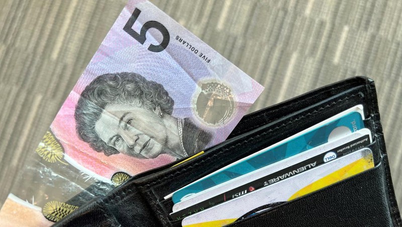 This photo illustration taken in Hong Kong on February 2, 2023 shows the Australian $5 banknote. - Australia's central bank announced on February 2, 2023 it will erase the British monarch from its banknotes, replacing the late Queen Elizabeth II's image on its $5 note with a design honouring Indigenous culture. (Photo by Mladen ANTONOV / AFP) (Photo by MLADEN ANTONOV/AFP via Getty Images)