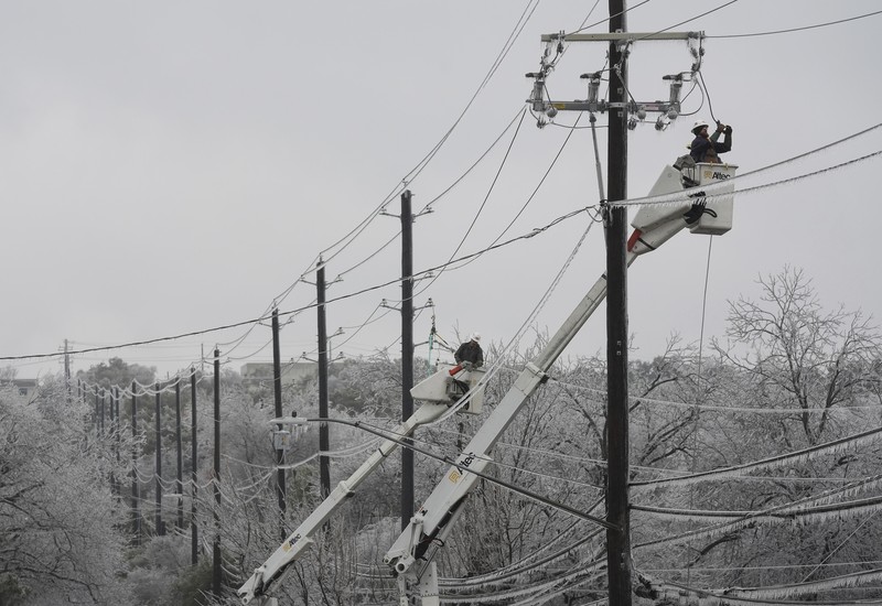 An icy mix covers the High Five Interchange at US 75 and I-635 on Tuesday, Jan. 31, 2023, in Dallas. Dallas and other parts of North Texas are under a winter storm warning that has been extended through Thursday. (Smiley N. Pool/The Dallas Morning News via AP)
