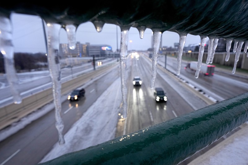 An icy mix covers the High Five Interchange at US 75 and I-635 on Tuesday, Jan. 31, 2023, in Dallas. Dallas and other parts of North Texas are under a winter storm warning that has been extended through Thursday. (Smiley N. Pool/The Dallas Morning News via AP)