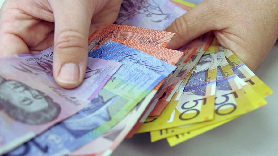 Australian banknotes are being counted in Canberra, Australia, May 1, 2009. Australia is removing the British monarchy from its bank notes. The nation's central bank said Thursday, Feb. 2, 2023, its new $5 bill would feature an Indigenous design rather than an image of King Charles III. (Alan Porritt/AAP Image via AP)