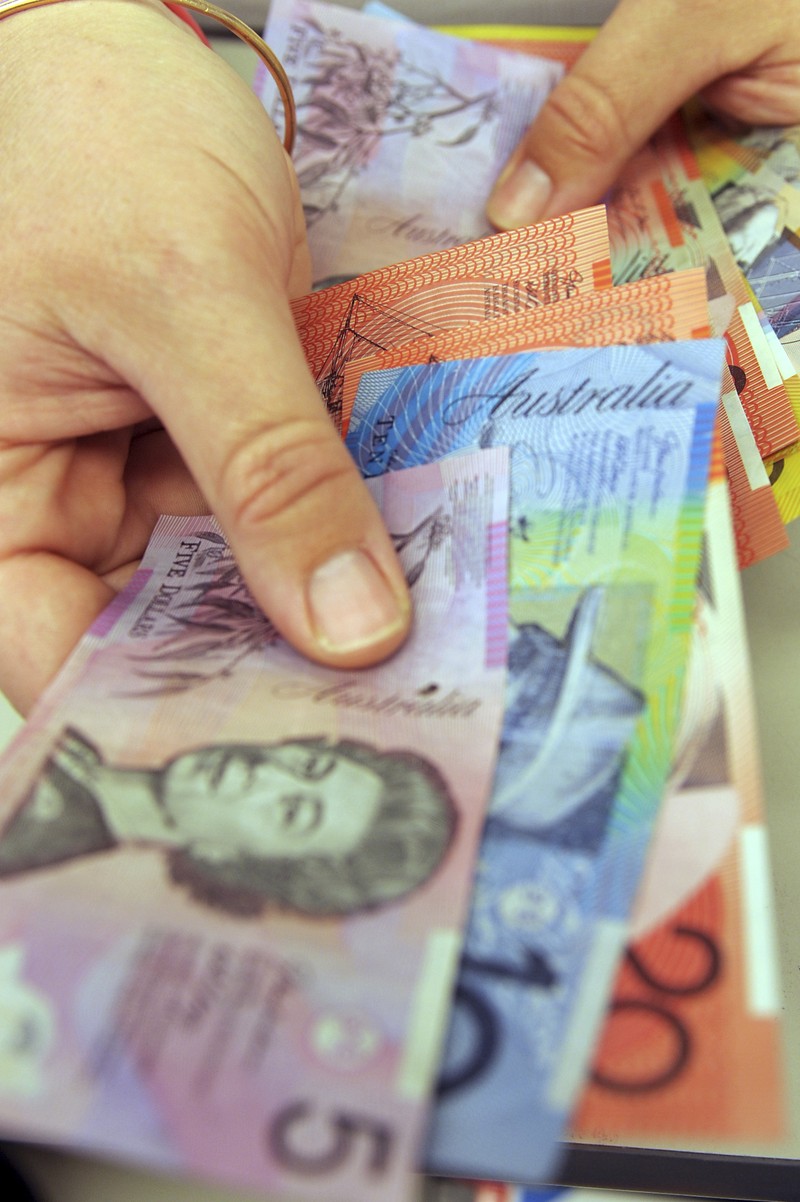 This photo illustration taken in Hong Kong on February 2, 2023 shows the Australian $5 banknote. - Australia's central bank announced on February 2, 2023 it will erase the British monarch from its banknotes, replacing the late Queen Elizabeth II's image on its $5 note with a design honouring Indigenous culture. (Photo by Mladen ANTONOV / AFP) (Photo by MLADEN ANTONOV/AFP via Getty Images)