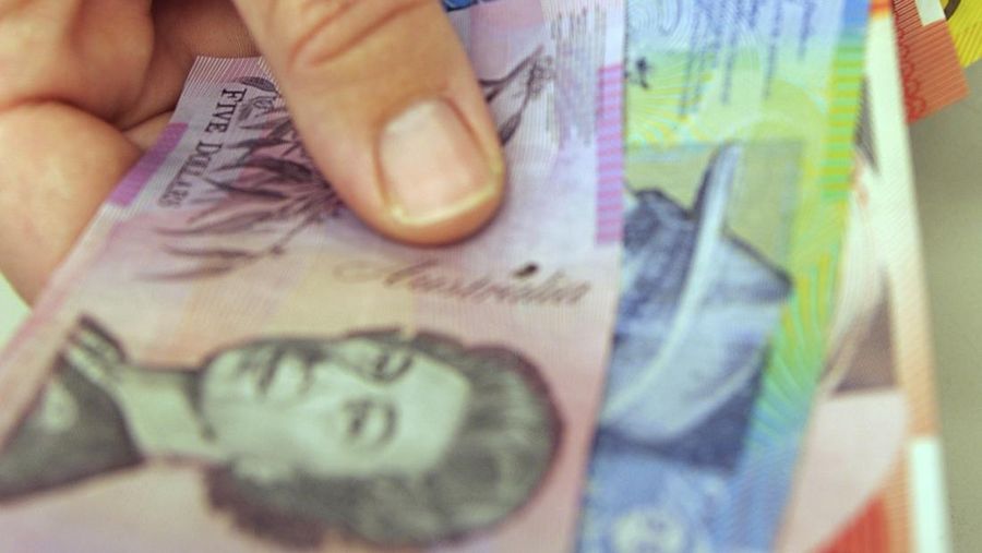 This photo illustration taken in Hong Kong on February 2, 2023 shows the Australian $5 banknote. - Australia's central bank announced on February 2, 2023 it will erase the British monarch from its banknotes, replacing the late Queen Elizabeth II's image on its $5 note with a design honouring Indigenous culture. (Photo by Mladen ANTONOV / AFP) (Photo by MLADEN ANTONOV/AFP via Getty Images)
