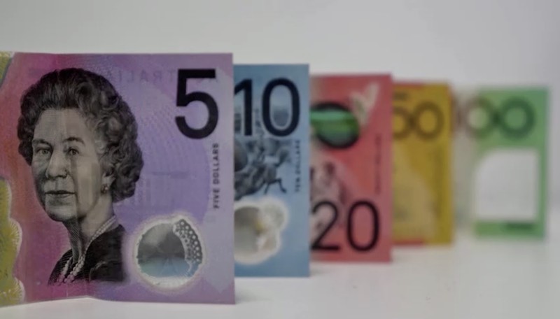 This photo illustration taken in Hong Kong on February 2, 2023 shows the Australian $5 banknote. - Australia's central bank announced on February 2, 2023 it will erase the British monarch from its banknotes, replacing the late Queen Elizabeth II's image on its $5 note with a design honouring Indigenous culture. (Photo by Mladen ANTONOV / AFP) (Photo by MLADEN ANTONOV/AFP via Getty Images)