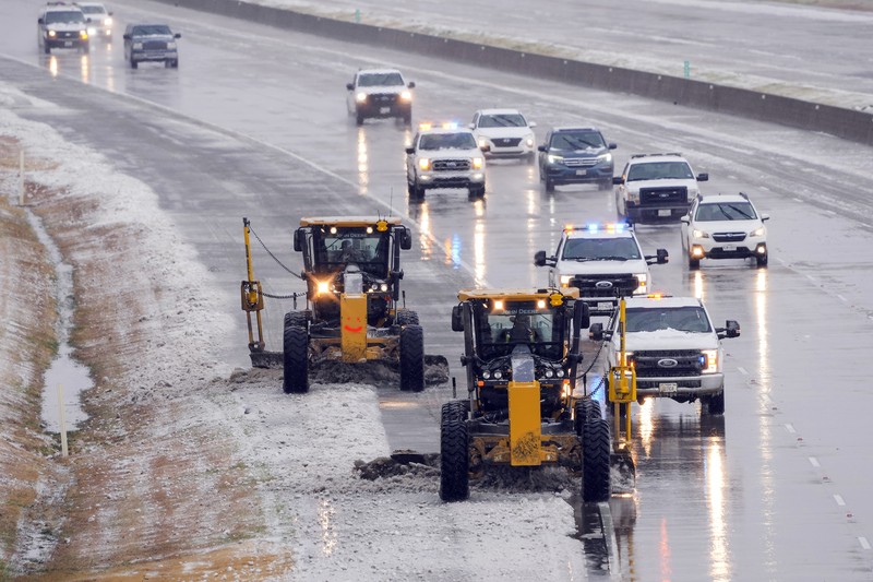 An icy mix covers the High Five Interchange at US 75 and I-635 on Tuesday, Jan. 31, 2023, in Dallas. Dallas and other parts of North Texas are under a winter storm warning that has been extended through Thursday. (Smiley N. Pool/The Dallas Morning News via AP)