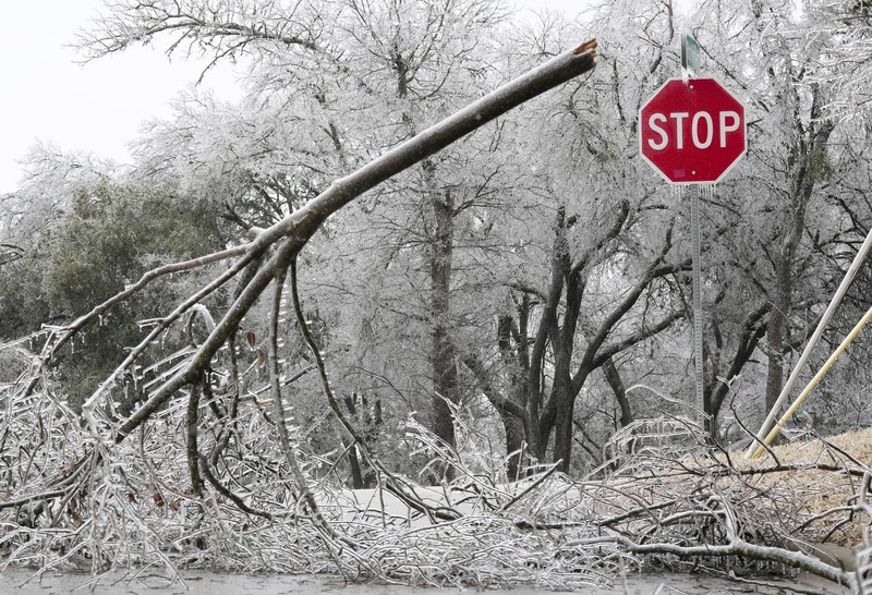 An icy mix covers the High Five Interchange at US 75 and I-635 on Tuesday, Jan. 31, 2023, in Dallas. Dallas and other parts of North Texas are under a winter storm warning that has been extended through Thursday. (Smiley N. Pool/The Dallas Morning News via AP)