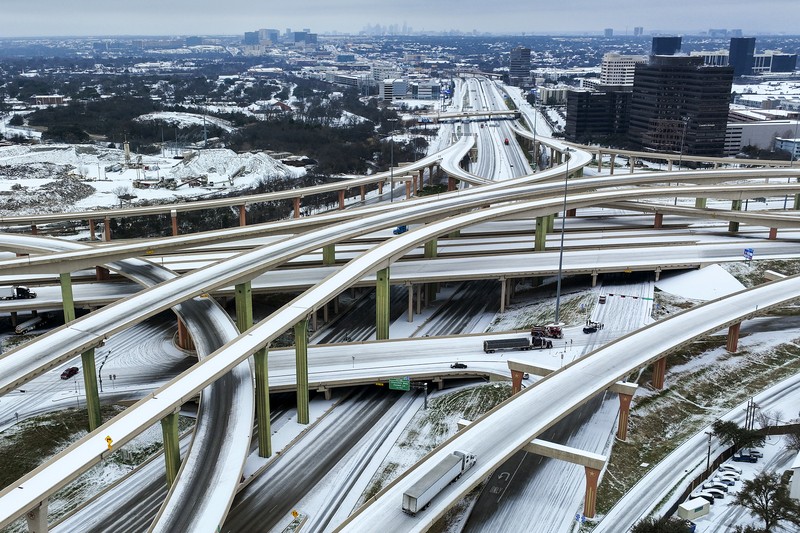 An icy mix covers the High Five Interchange at US 75 and I-635 on Tuesday, Jan. 31, 2023, in Dallas. Dallas and other parts of North Texas are under a winter storm warning that has been extended through Thursday. (Smiley N. Pool/The Dallas Morning News via AP)