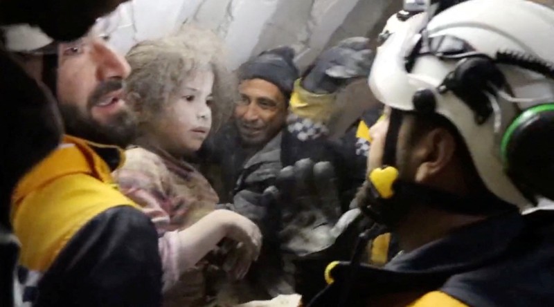 TURKEY-QUAKE/SYRIA-AZMARIN RESCUE A child is rescued from the rubble in the aftermath of an earthquake in Azmarin, Syria, February 7, 2023 in this still image taken from video. White Helmets/Handout via REUTERS THIS IMAGE HAS BEEN SUPPLIED BY A THIRD PARTY. NO RESALES. NO ARCHIVES. MANDATORY CREDIT