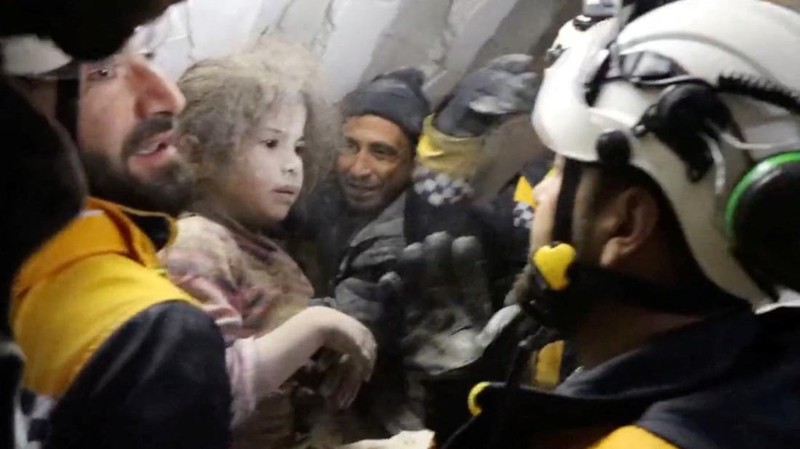A child is rescued from the rubble in the aftermath of an earthquake in Azmarin, Syria, February 7, 2023 in this still image taken from video.  White Helmets/Handout via REUTERS    THIS IMAGE HAS BEEN SUPPLIED BY A THIRD PARTY. NO RESALES. NO ARCHIVES. MANDATORY CREDIT