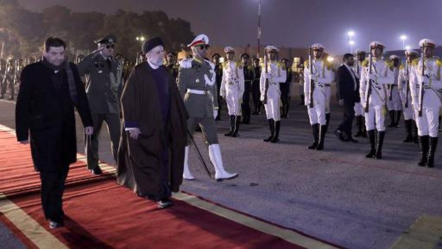 This handout picture provided by the Iranian Presidency shows Iran's President Ebrahim Raisi (3rd-L) being escorted by government officials on his way to his aircraft as he departs from the capital Tehran's Mehrabad International Airport in Tehran on February 13, 2023 for a visit to China. (Photo by Iranian Presidency / AFP) / === RESTRICTED TO EDITORIAL USE - MANDATORY CREDIT 