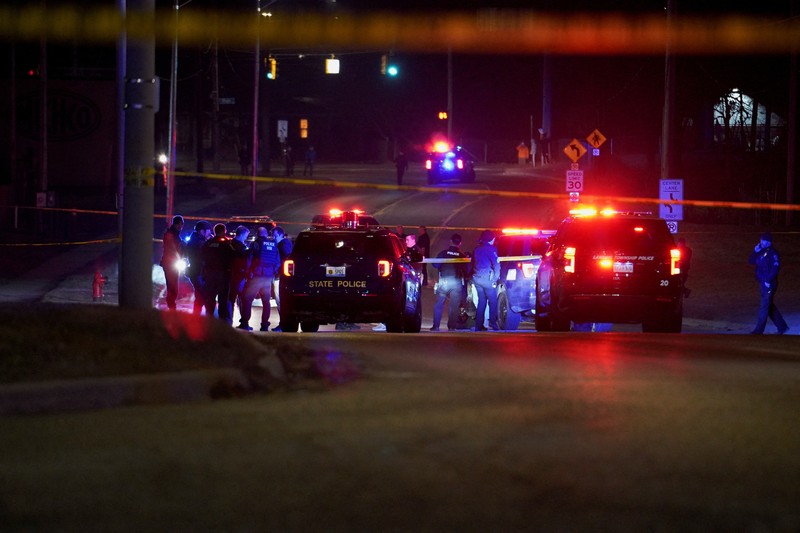 Petugas polisi berjalan di dekat lokasi tersangka berada ketika mereka menanggapi penembakan di Michigan State University di East Lansing, Michigan, AS, 14 Februari 2023. (REUTERS/Dieu-Nalio Chery )
