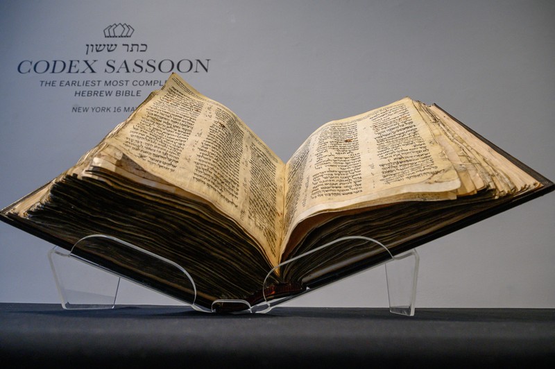 1466421806 NEW YORK, NEW YORK - FEBRUARY 15: A view of the Codex Sassoon at Sotheby's on February 15, 2023 in New York City. The codex is the oldest surviving Hebrew Bible or Tanakh as its used today in contrast to the dead sea scrolls which are older but the books are in separate scrolls. The Book is approximately 1000 years old and is estimated to be auctioned at 30-50 Million dollars and that would make it the most valuable historical document to appear in auction. (Photo by Roy Rochlin/Getty Images)
