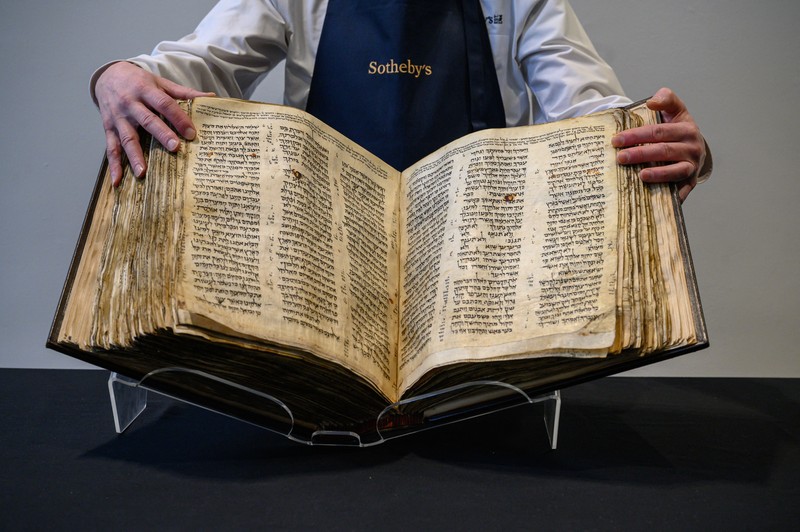 1466421806 NEW YORK, NEW YORK - FEBRUARY 15: A view of the Codex Sassoon at Sotheby's on February 15, 2023 in New York City. The codex is the oldest surviving Hebrew Bible or Tanakh as its used today in contrast to the dead sea scrolls which are older but the books are in separate scrolls. The Book is approximately 1000 years old and is estimated to be auctioned at 30-50 Million dollars and that would make it the most valuable historical document to appear in auction. (Photo by Roy Rochlin/Getty Images)