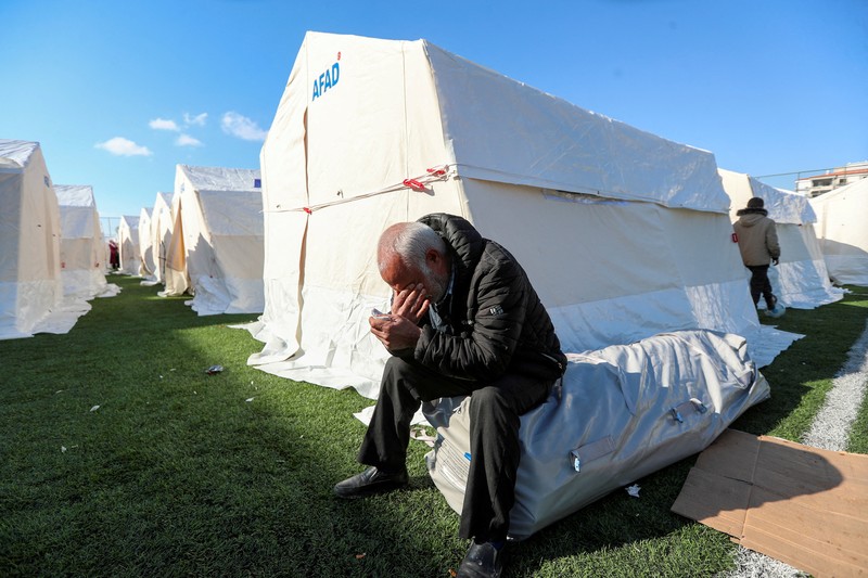 A man prays near the rubble of destroyed homes, in the aftermath of a deadly earthquake in Kahramanmaras, Turkey February 14, 2023. REUTERS/Nir Elias     TPX IMAGES OF THE DAY