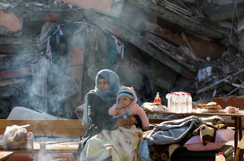 A man prays near the rubble of destroyed homes, in the aftermath of a deadly earthquake in Kahramanmaras, Turkey February 14, 2023. REUTERS/Nir Elias     TPX IMAGES OF THE DAY