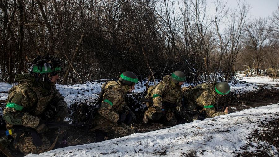Ukrainian servicemen take cover during a shelling outside the frontline town of Bakhmut, amid Russia's attack on Ukraine, in Donetsk region, Ukraine February 13, 2023. REUTERS/Yevhenii Zavhorodnii