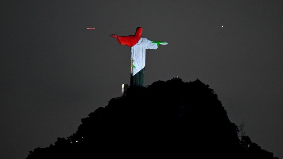 A lightning flashes over the statue of Christ the Redeemer on top of the Corcovado hill in Rio de Janeiro, Brazil, on January 16, 2014.  AFP PHOTO / YASUYOSHI CHIBA        (Photo credit should read YASUYOSHI CHIBA/AFP via Getty Images)