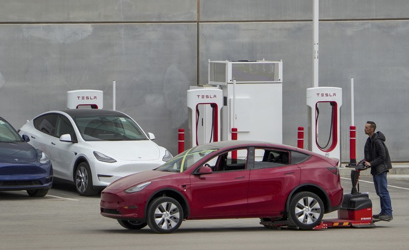 Tesla cars sit at Tesla's Giga Texas automotive manufacturing facility in Austin, Texas, on Thursday, Feb. 16, 2023. U.S. safety regulators have pressured Tesla into recalling nearly 363,000 vehicles with its “Full Self-Driving” system because it misbehaves around intersections and doesn't always follow speed limits.  (Jay Janner/Austin American-Statesman via AP)