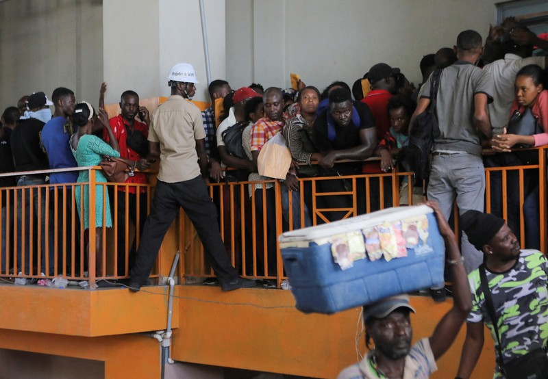 People try to force their way in to apply for a passport at an immigration office, in Port-au-Prince, Haiti February 17, 2023. REUTERS/Ralph Tedy Erol
