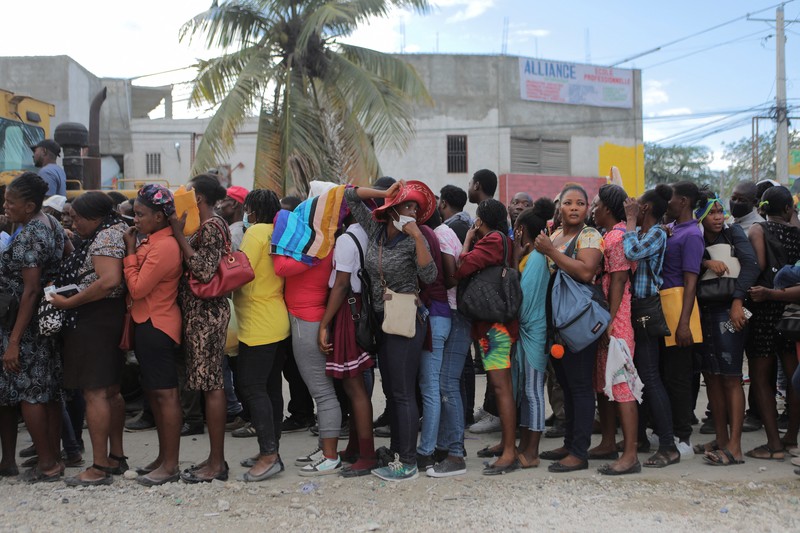 People try to force their way in to apply for a passport at an immigration office, in Port-au-Prince, Haiti February 17, 2023. REUTERS/Ralph Tedy Erol