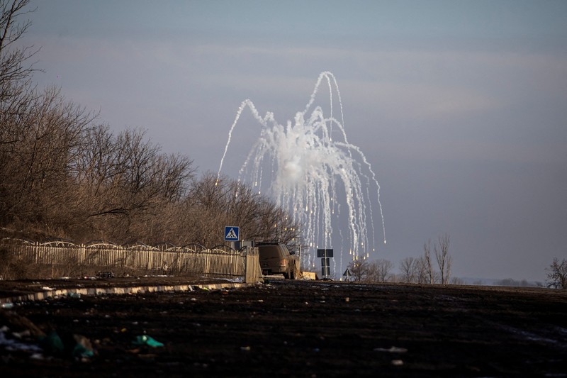 UKRAINE-CRISIS/BAKHMUT-WARCRIMES FILE PHOTO: An explosion is seen on a road outside the frontline town of Bakhmut, amid Russia's attack on Ukraine, in Donetsk region, Ukraine February 10, 2023. REUTERS/Yevhenii Zavhorodnii/File Photo